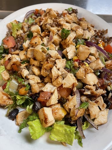 grilled chicken mexican salad with lettuce onions corn tomato and black beans
