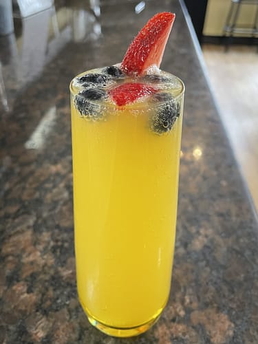 mimosa with strawberries and blueberries