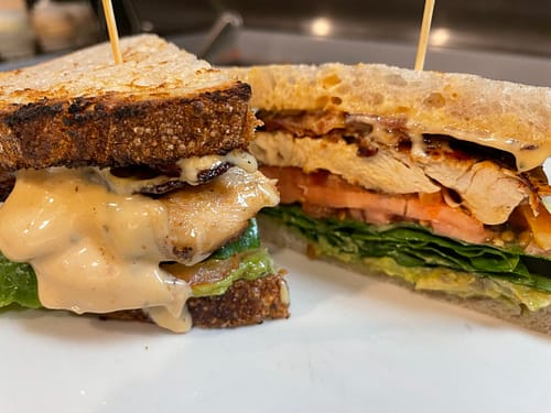 grilled chicken sandwich with avocado tomato lettuce and aioli